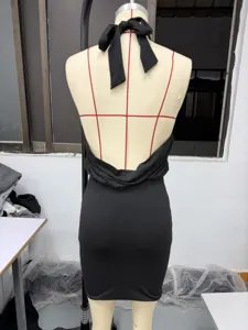 Detail view of the sexy backless halter neck strap design on the black party mini dress.