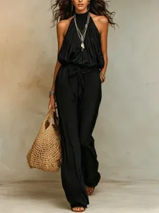 Chic black halter wide-leg jumpsuit for women, sleeveless Bohemian resort wear style.