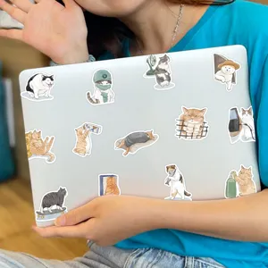 Waterproof cute cat stickers detail, funny vinyl decal design for laptop and luggage decor.