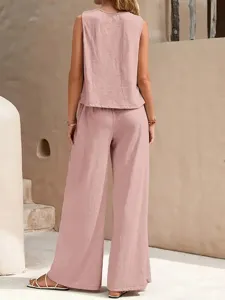 Solid color elegant two-piece set featuring a crew neck tank top and wide leg pants detail.