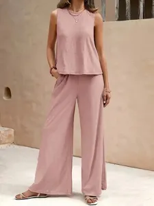 Close-up detail of the elegant solid color sleeveless tank top and wide-leg pants outfit.