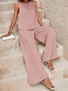 Casual dusty pink sleeveless top and wide leg trousers two piece set on stone stairs.