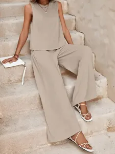 Detail view of elegant solid color two-piece set, featuring tank and pants on steps.