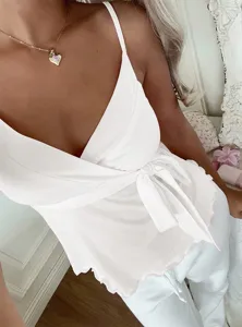 Details of white V-neck wrap camisole top with tie waist and ruffled hem for women.