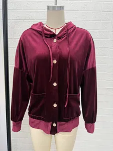 Close-up detail of women velvet hooded cardigan, soft fabric, wooden button and pocket trim.