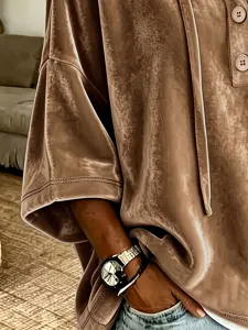 Close-up of women's velvet short sleeve hoodie detail, showing soft fabric texture and buttons.