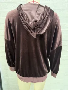 Detail view of women's brown velvet hooded sweatshirt featuring long sleeves and ribbed hem.