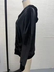 Detailed side view of women black velvet hooded cardigan, soft fabric texture.