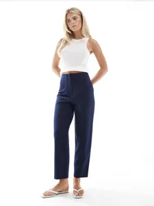 Detailed view of women's high-waisted navy trousers, straight leg design, professional wear.
