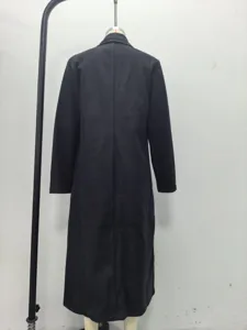 Detailed view of the back of a black long woolen trench coat showing seam structure.