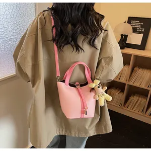 Sweet pink leather bucket bag with cute dog pendant, stylish daily shoulder bag for women.