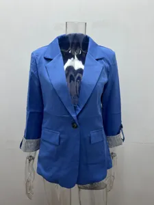 Detail shot of a blue slim-fit blazer jacket with 3/4 rolled striped cuffs and single button.