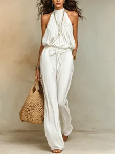 Detail shot of a white halter neck jumpsuit featuring a chic cinched waist and wide leg.