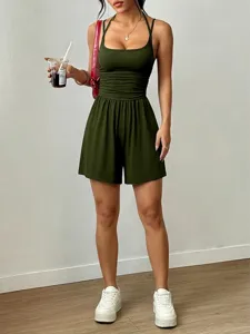 Close-up detail of the stylish olive green halter romper, showcasing the ruched waist and fit.