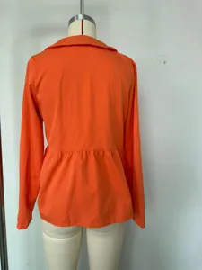 Back detail view of orange long sleeve casual shirt showing lapel collar and loose hemline.