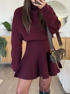 Detailed view of women's burgundy knit turtleneck sweater and skirt set, cozy autumn wear.