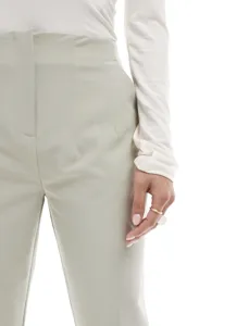 High-waist straight leg suit pants detail, elegant light green trousers for women commute.