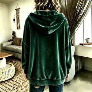 Back view of dark green velvet hooded cardigan jacket, casual oversized style detail.