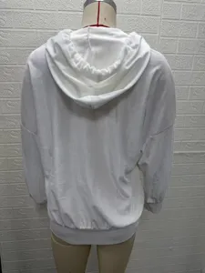 Detail view of a solid white hooded long-sleeve top for women, featuring soft plush fabric.