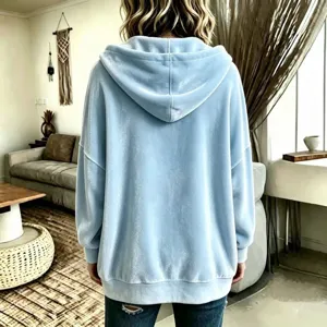 Light blue velvet hoodie back detail, soft textured fabric with cozy hooded design for casual wear.