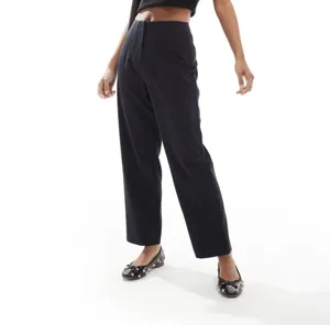 Women's high waist black straight trousers elegant casual workwear pants detail view.