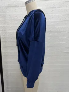 Detailed view of the dark blue velvet long sleeve hooded top, soft texture and cozy fit.