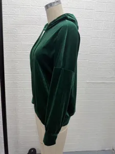Detail view of women's dark green velvet hoodie with drawstring and long sleeves.