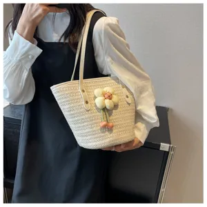 Women summer woven straw bucket shoulder bag with cute fabric flower pendant for daily beach.