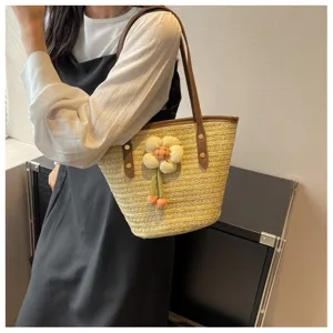 Woven straw shoulder bag for women, large capacity summer beach tote with cute flower pendant.