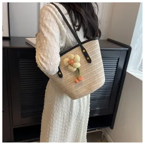 Woven straw shoulder bag for women, large capacity summer beach bucket bag with cute floral decor.