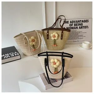 Detailed view of women's woven straw bucket bag, large capacity summer beach shoulder bag.