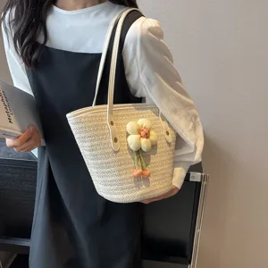Woven straw bucket bag for women, large capacity summer beach shoulder bag with floral decor.