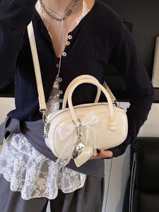 Chic white bowling bag for women, trendy lace bow crossbody handbag with stylish heart charm.
