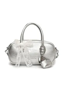 Silver bowling handbag for women with white lace bow and heart pendant, stylish crossbody bag.