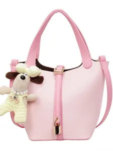 Pink leather bucket bag with cute dog pendant, stylish women's shoulder commuting handbag.