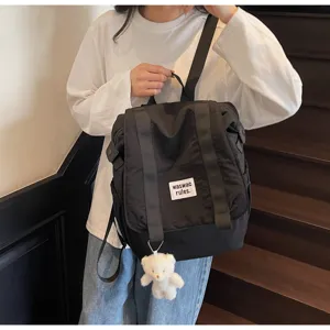 Casual large capacity nylon backpack for women, lightweight versatile travel school bag detailing.