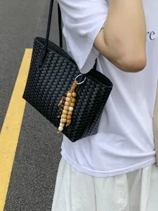 Black woven leather tote bag for women, large capacity minimalist shoulder bag for commuting.