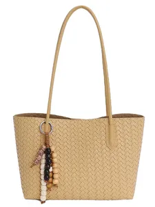 Elegant beige woven leather tote bag with double shoulder straps and chic beaded charm pendant.