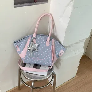 Detailed view of a fashionable large-capacity blue and pink polka dot women shoulder tote bag.