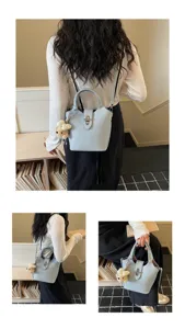 Stylish light blue bucket bag for women, chic shoulder crossbody bag with cute bear charm.