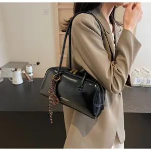 Women vintage black patent leather shoulder underarm pillow bag detail view, stylish bag