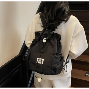 Black canvas drawstring backpack for women, casual lightweight travel school book bag detail view.