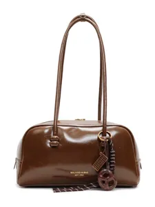 Brown patent leather shoulder bag for women, vintage retro pillow bag with stylish charms.