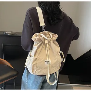 Detailed view of beige casual drawstring backpack, lightweight nylon material, ideal daily use.