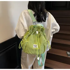 Lightweight canvas drawstring backpack for women, casual daily daypack with large capacity.