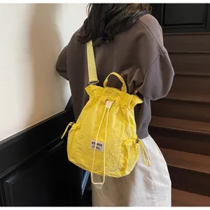 Yellow canvas drawstring backpack for women, casual school bookbag and travel daypack.