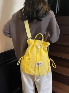 Yellow canvas drawstring backpack for women, casual daily school bookbag and travel daypack.