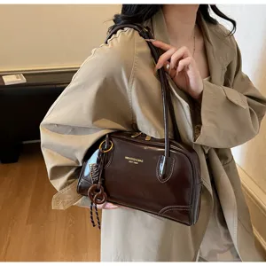 Brown patent leather underarm pillow shoulder bag, vintage commuter daily handbag detail.