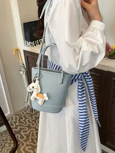 Litchi pattern leather bucket bag for women, stylish shoulder and crossbody handbag.