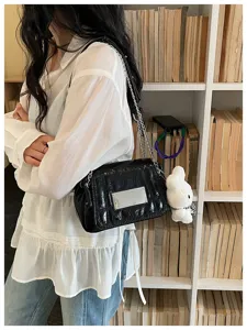Black crinkled leather chain shoulder crossbody bag for women, chic niche design for daily spring use.